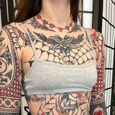 a woman with lots of tattoos on her chest