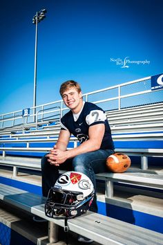 a young man sitting on the bleachers with his football helmet and glove in hand