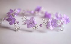 a close up of a bracelet with flowers on it