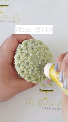 a person is painting flowers with yellow paint on the top and bottom of their fingers