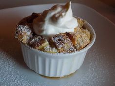 a dessert dish with powdered sugar and whipped cream