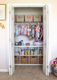 an organized closet with books, toys and other items in baskets on the bottom shelf