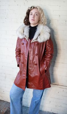 "This 1970s oxblood genuine leather jacket has a soft white fur collar. Real leather jacket that falls to the mid thigh with two pockets and three button closure.  Maker: Anshire Original, Ladies Garmetn Worker Union made in the USA | Material: 100% genuine leather CONDITION: very good to excellent condition with no flaws of note.  Medium | Measurements (taken flat): 17\" Shoulder to shoulder / 19\" Bust / 18\" Hips / 34\" Length / 22\" Sleeve length Model is 5'5\" and wears modern size 6 with 2 Womens Leather Coats, Leather Jacket With Fur Collar, Leather Jacket With Fur, Jacket With Fur Collar, Leather Clothes, Functional Wardrobe, Leather Coat Womens, Workers Union, Refined Fashion