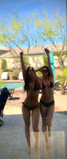 two women in bikinis standing next to each other