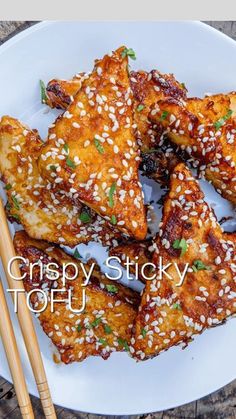 chicken wings on a plate with sesame seeds and chopsticks