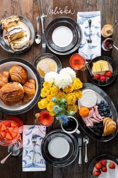 a table topped with black plates filled with food