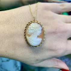 Metal: 14kt Yellow Gold Stone: Shell Shape: Oval Weight of entire piece with chain: 6.60 grams Length Of Cameo Including Bail: 33.00 mm Width Cameo : 23.00 mm Closer Type: Pin Stem With Side Catch Closer Age: Vintages, approximately from the 1960's. Type Of Chain: Rolo Chain Width Of Chain: 1.00mm Type Of Lock: Lobster Lock Length Of Chain: 18inches Jewelry Type: The back on this cameo has a pin to wear it as a brooch, as well as a loop that folds back and forth wear it as a pendant, on a chain. Luxury 14k Gold Brooch Jewelry, Fine Jewelry Necklaces With Brooch For Anniversary, Elegant Gold Necklace With Brooch, Antique Yellow Gold Necklace With Cabochon, Elegant Cameo Round Pendant Jewelry, Oval Brooch Jewelry For Anniversary, Yellow Gold Round Brooch, Oval Brooch Necklaces For Wedding, Elegant Medallion Shaped Brooch Jewelry