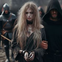 two people dressed in medieval costumes standing next to each other and one person with white makeup on his face