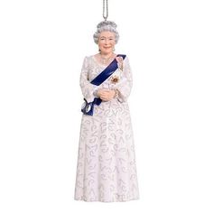 a figurine of an old woman wearing a tiara and holding a blue ribbon