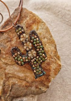 "A rustic and whimsical hand wire wrapped and beaded cactus necklace that would make a great gift for anyone who loves the desert! I wired a mixture of Czech glass beads and flowers in tan and olive green onto the cactus frame for rich color and texture.  The pendant is 2.75 \" long and hangs from an 20\" soft leather cord." Beaded Cactus, Desert Jewelry, Cactus Necklace, Desert Cactus, Rustic Jewelry, Inspirational Jewelry, Beaded Hoop Earrings, Beaded Hoops, Color And Texture