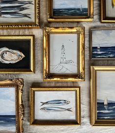 many framed pictures are hanging on the wall next to each other, including one with a sailboat