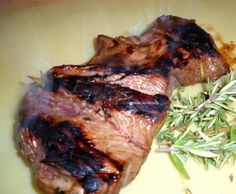 two pieces of meat sitting on top of a yellow plate