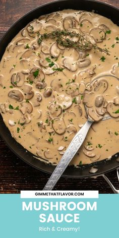 a pan filled with mushrooms and sauce on top of a wooden table