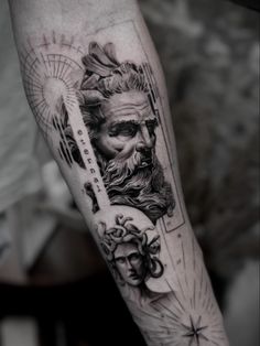 a man's arm with a tattoo on it and an image of the god