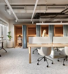 an office space with two desks and chairs