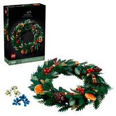 the lego christmas wreath is next to its box