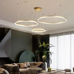 a living room filled with furniture and lots of lights hanging from the ceiling above it