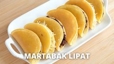 some food is on a white platter with the words martabak lipat