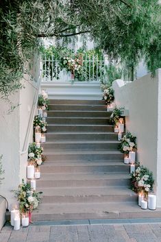 an outdoor staircase decorated with candles and flowers