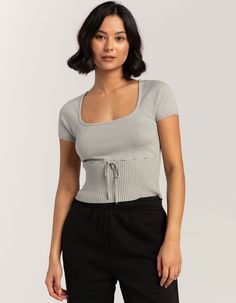 Rsq Ribbon Rib Sweater. This Sweater Features A Unique Design With A Wide Rib Hem, Offering A Contemporary Twist On A Classic Silhouette. The Addition Of Ribbon Detailing At The Waist Adds A Touch Of Sophistication And A Playful Accent To Elevate Your Look. Scoop Neckline. Short Sleeve. 50% Rayon, 28% Polyester, 22% Nylon. Machine Wash. Imported. Model Is Wearing A Size Medium. Model Measurements:height: 5'8" Bust: 32"waist: 25"hips: 36" Cute Work Tops, Fitted Gray Knit Top For Spring, Wide Rib Cage Body Types, Jersey Top Outfit, College Clothes, Top Summer Outfits, Rib Sweater, Tiktok Outfits, Rib Knit Top