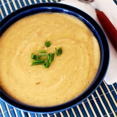 a blue bowl filled with soup on top of a table