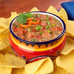 a bowl of chili with tortilla chips on the side