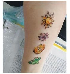 a person with a tattoo on their arm and foot that has pictures of different things on it