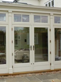 two white double doors with glass panes in front of them