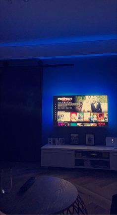 a flat screen tv sitting on top of a white entertainment center in a living room