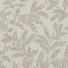 an upholstered wallpaper with green leaves and branches on white fabric, the background is