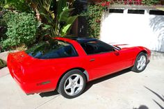 a red sports car parked in front of a house