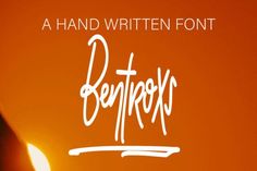 a handwritten font with a candle in the background