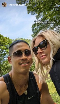 a man and woman taking a selfie in the park