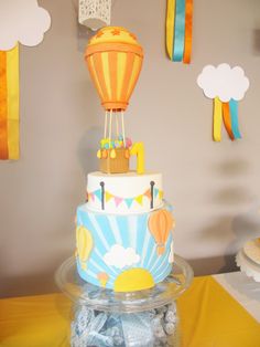 a birthday cake with hot air balloons on top