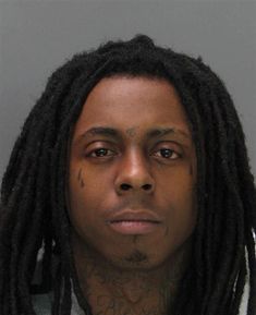 a man with dreadlocks is shown in this mug shot