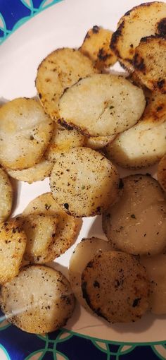 some fried potatoes are on a blue and white plate