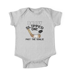 a baby bodysuit that says daddy slipped one past the goalie