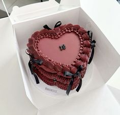 a heart shaped cake in a white box