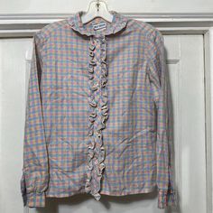 Vintage Pastel Ruffle Checker Print Button Down Blouse Brand is Chez-Belle.  65% polyester 34% cotton 1% lurex.  Made in the  USA.  The bust measures 19'' flat across armpit to armpit and the length from shoulder seam to bottom along the side is 21.5''.  No rips or stains.  Fits like a small. Checker Print, Button Down, Button Down Blouse, Womens Clothing Tops, Blouses For Women, Art Collection, Top Blouse, Bathing Beauties, Pastel