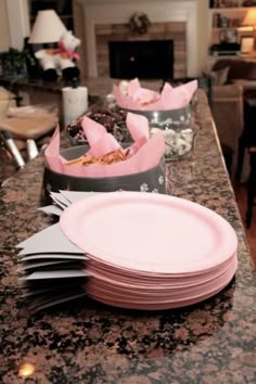 there are many pink plates on the counter