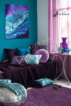 a bedroom with purple and blue decor on the walls, bedding and rugs