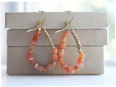 Beaded Hoop Earrings, Orange Sunstone and African Brass, Bohemian Beadwork Earrings, Earthy Earrings, Dangle EarringsShimmering orange sunstone and juicy red aventurine, along with African brass, make up these approximately 2" dangle drop hoop earrings. Casual and dressy depending on the occasion, they make a simple and elegant statement. Strung on 49-strand, soft-drape steel cable, these beaded hoop earrings also include delicate brass lever back ear wires.All pieces are satisfaction guaranteed Bohemian Gemstone Beads Earrings, Bohemian Teardrop Earrings With Natural Stones, Bohemian Drop Earrings With Gemstone Beads, Bohemian Gemstone Beaded Earrings As Gift, Bohemian Teardrop Gemstone Bead Earrings, Earthy Earrings, Earrings Casual, Red Aventurine, Beadwork Earrings