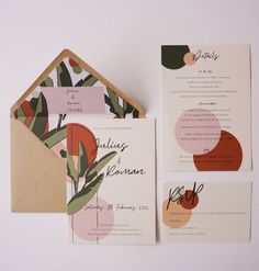 the wedding stationery is laid out on top of each other