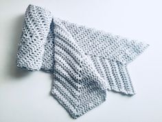 two crocheted dishcloths sitting next to each other