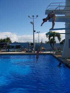 a person jumping into a swimming pool