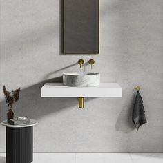 a white sink sitting under a mirror next to a wall mounted faucet in a bathroom