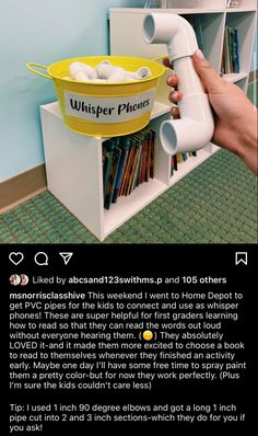 a person holding a white object in front of a book shelf