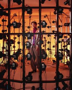 a man standing in front of an array of wires and electronic equipment with the word w on it