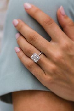 a woman's hand with a diamond ring on it