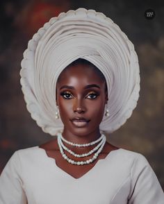 an african woman wearing a white turban and pearl necklace